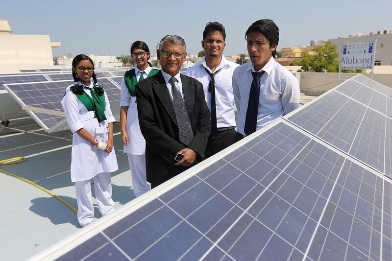 Principal Mir Hasan and pupils, from left, Asthma Amree, 12, Zarin Isra, 13, Mohammed Nur, 18, and Fahad Bashar, 17, with the solar panels that now power all of the school’s lighting, computers and fans. Sammy Dallal / The National