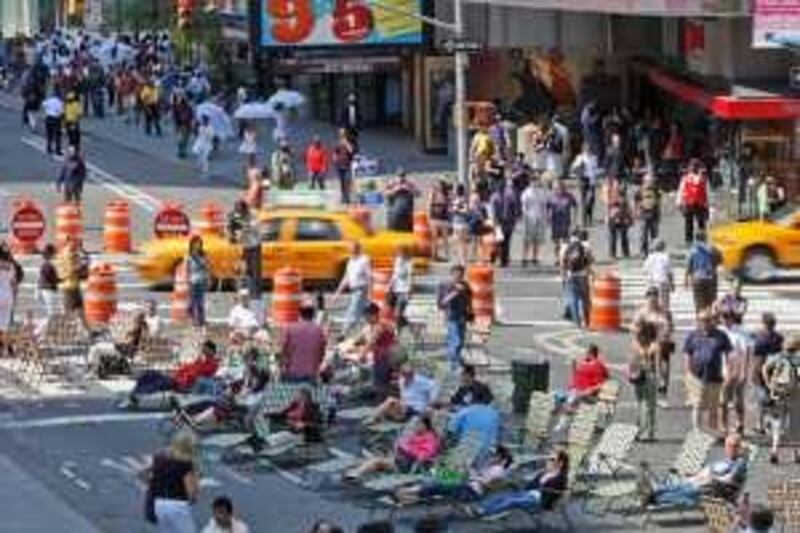 Pedestrians take a break on lounge chairs in the middle of Broadway in New York's Times Square, Monday, May 25, 2009.  Sections of Broadway that run through Times Square and Herald Square have been closed to cars in a city effort to reduce traffic and pollution and cut down on pedestrian accidents. (AP Photo/Seth Wenig)