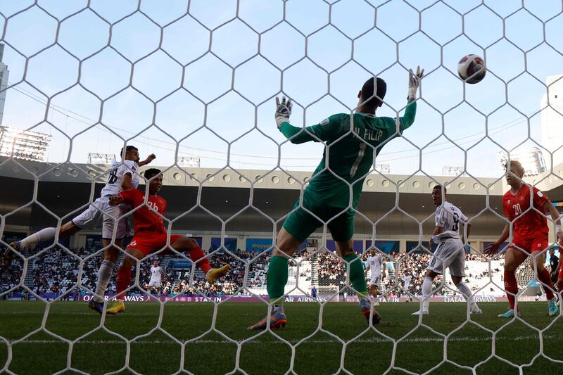 Iraq's forward Aymen Hussein heads in to make it 2-1. AFP