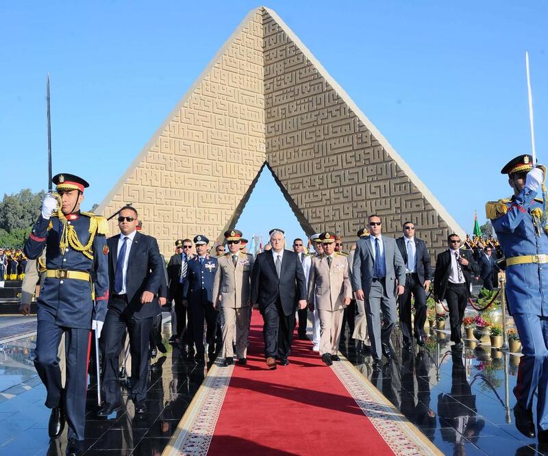 Egypt’s interim president Adly Mansour, centre, takes part in a ceremony at the memorial of the Unknown Soldier and tombs on Saturday as part of the celebrations marking the 40th anniversary of the October 6 war. AFP
