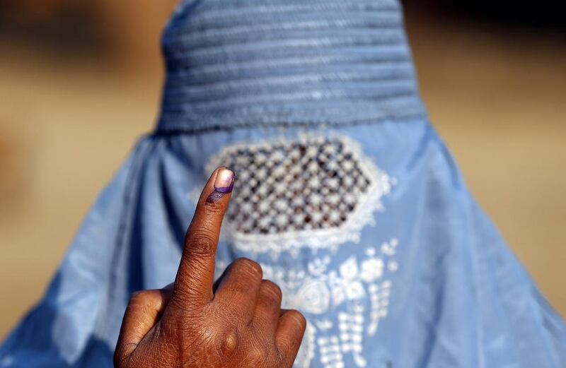 A woman shows her ink marked finger after voting during the state assembly election, in the village of Kairana, in the state of Uttar Pradesh.  Cathal McNaughton / Reuters