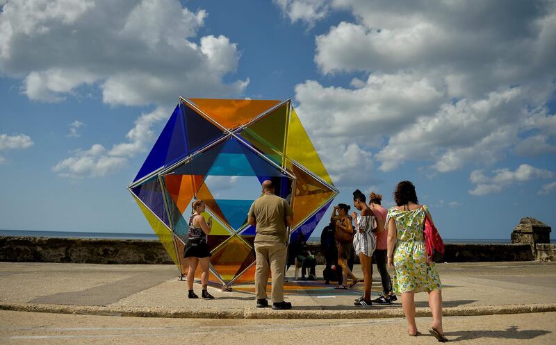 People observe new installations at the inauguration of the Havana Biennial's open-air exhibition 'Detras del Muro' (Behind the Wall). AFP