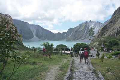 People walking to Pinatubo Crater in Philippines. Getty Images