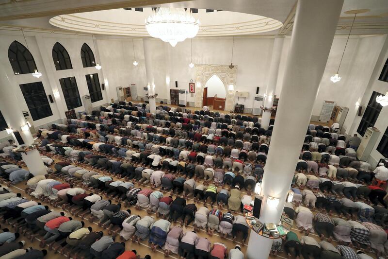 Dubai, United Arab Emirates - May 16, 2019: People pray after Iftar. Mosque series for Ramdan. Lootah Masjid Mosque is an old mosque in Deira. Thursday the 16th of May 2019. Deira, Dubai. Chris Whiteoak / The National