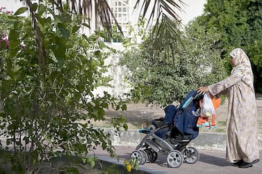 A domestic worker takes a child out for a stroll in Dubai. Both expatriates and citizens can now only sponsor domestic workers via Tadbeer centres, while all private recruitment agencies are being shut down. Photo: The National Archives 
