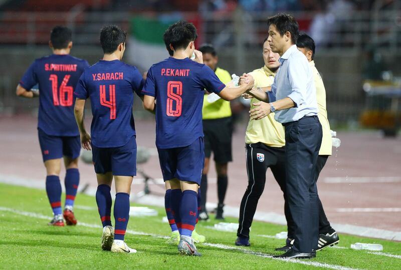 Thailand's Eakkanit Punya celebrates with manager Akira Nishino after scoring their second goal . Reuters