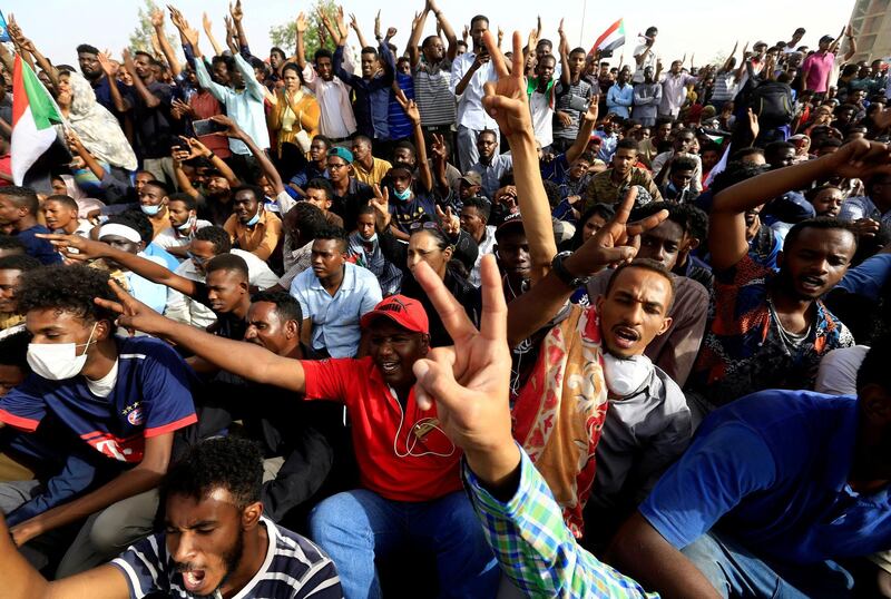 Sudanese demonstrators cheer as they attend a protest rally in Khartoum. Reuters