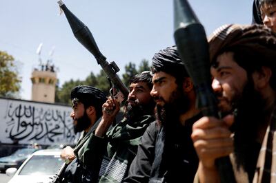 Taliban soldiers celebrate on the second anniversary of the fall of Kabul  near the US embassy in Kabul. Reuters 