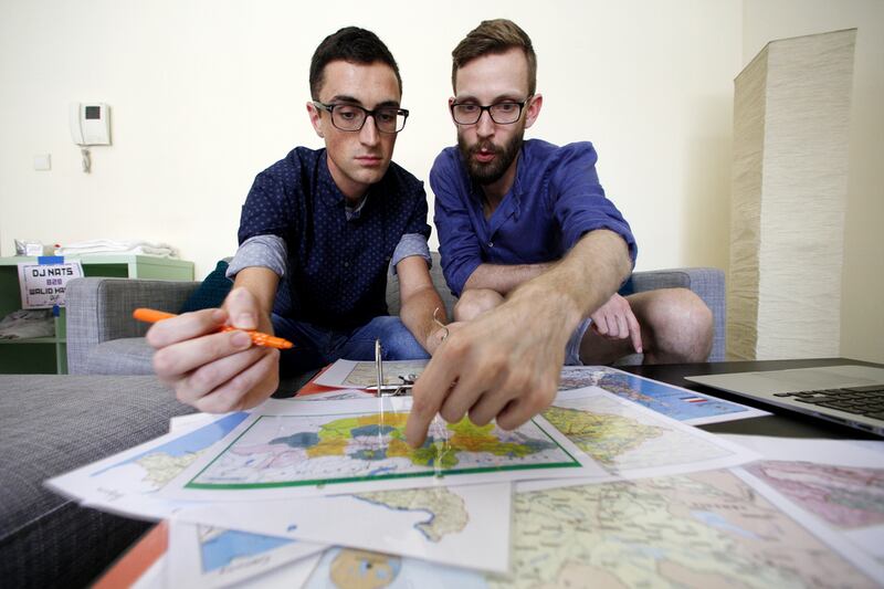 William Harbidge, left, and David Knapp map out their Mongol Rally route on July 9, 2015, at home in the Khalifa City area villa of Abu Dhabi. The pair and a friend will take part in the month-long overland road trip from London to Ulan Bator, Mongolia. Christopher Pike / The National
