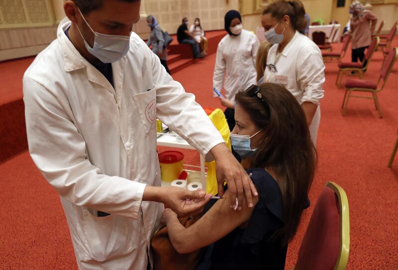 A woman receives a coronavirus disease vaccine at a vaccination centre in Tunis, Tunisia