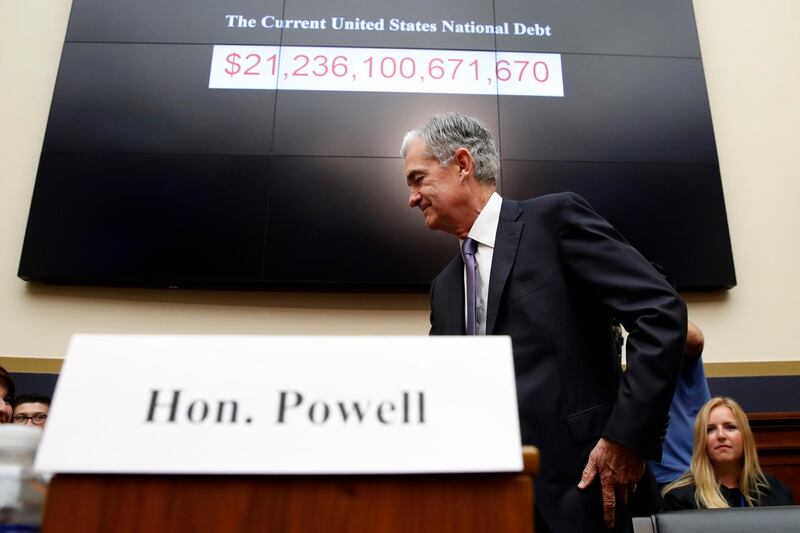 FILE- In this July 18, 2018, file photo Federal Reserve Board Chair Jerome Powell arrives to testify at a House Committee on Financial Services hearing on Capitol Hill in Washington. Powell gives the keynote address Friday, Aug. 24, at an annual conference of central bankers in Jackson Hole, Wyo. (AP Photo/Jacquelyn Martin, File)