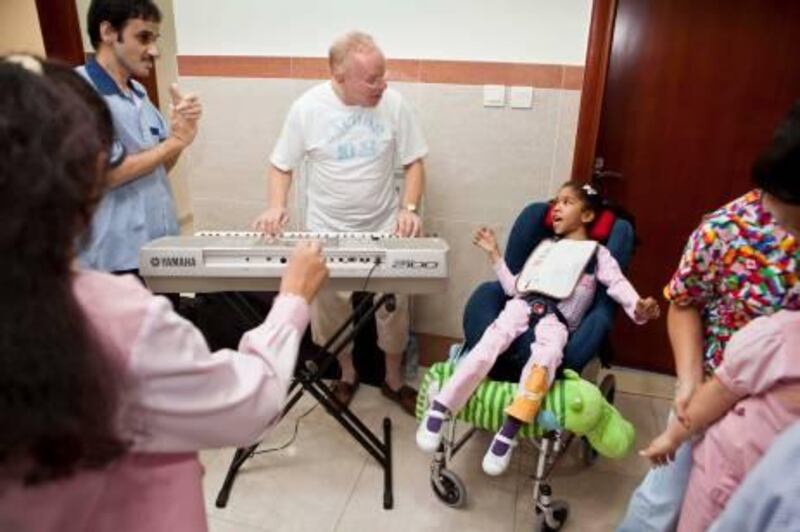 July 13. Jimmy Miller plays music therapy for the Special Needs kids at Senses Center. To his left in the wheelchair is one of the kids named Hind. July 13, Dubai, United Arab Emirates (Photo: Antonie Robertson/The National)