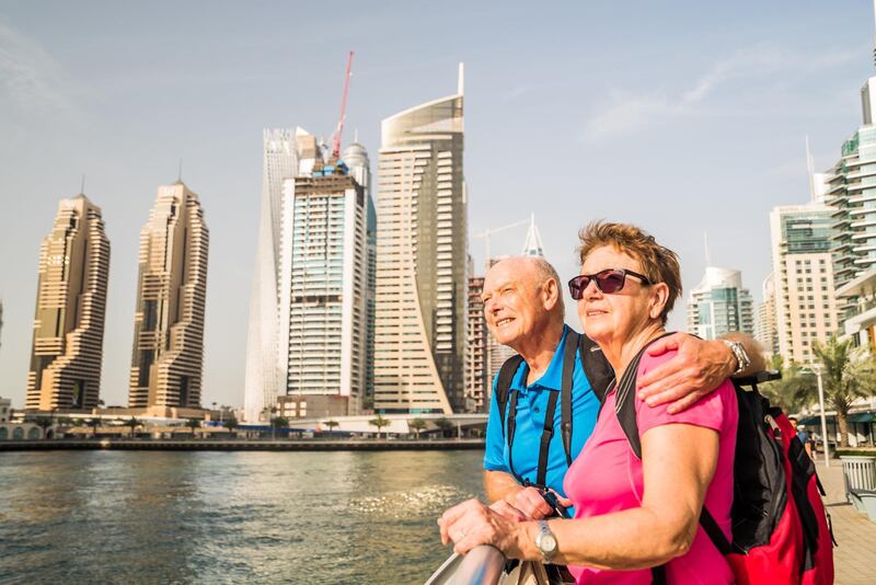 happy smiling active senior tourist couple together on sightseeing vacation through United Arab Emirates