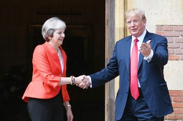 US President Donald Trump and Britain's Prime Minister Theresa May shake hands in July 2018. AFP