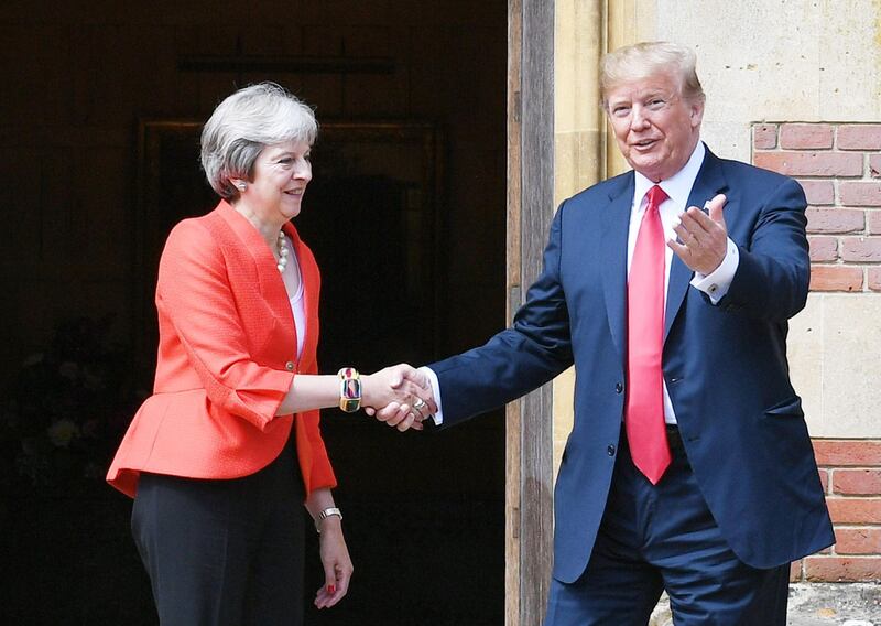 US President Donald Trump (R) and Britain's Prime Minister Theresa May (L) shake hands upon Trump's arrival for a meeting at Chequers, the prime minister's country residence, near Ellesborough, northwest of London on July 13, 2018 on the second day of Trump's UK visit. US President Donald Trump launched an extraordinary attack on Prime Minister Theresa May's Brexit strategy, plunging the transatlantic "special relationship" to a new low as they prepared to meet Friday on the second day of his tumultuous trip to Britain. / AFP / POOL / Stefan Rousseau
