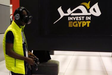 An African visitor uses virtual reality glasses at the Africa 2018 Forum at Red Sea resort city of Sharm el-Sheikh. Reuters