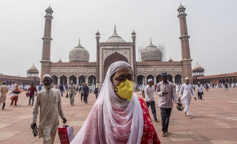 An Indian Muslim woman wearing a protective mask leaves after attending congregational Friday prayers at the historic Jama Masjid (Grand Mosque) amid the government imposing restriction on assembly of more than 20 people over the coranavirus threat in Delhi, India. Getty Images
