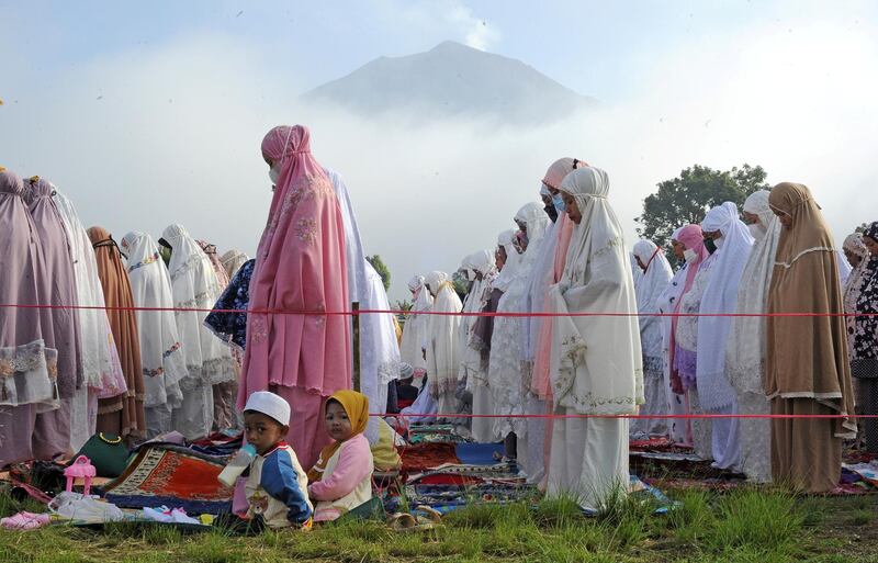 Indonesian Muslims attend mass prayers as Mount Kerinci volcano is visible in the background during Eid Al Fitr, marking the end of Ramadan. Reuters