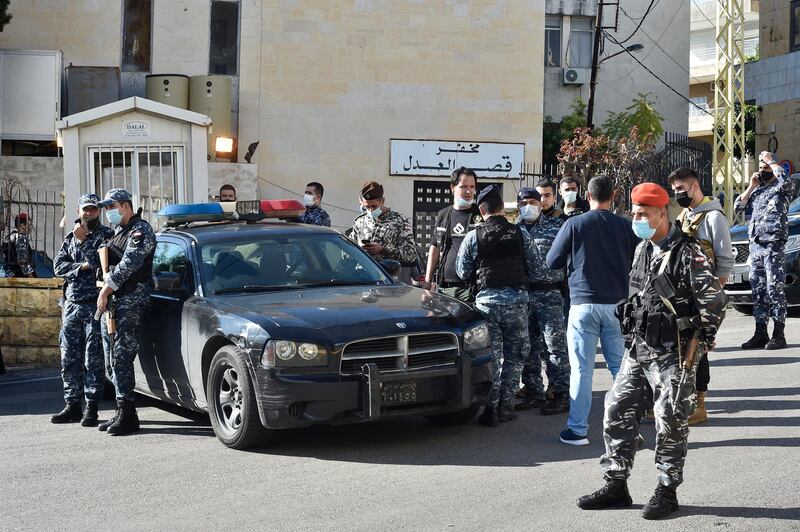 Lebanese policemen stand guard outside a detention center after dozens of prisoners escaped in Baabda.  EPA