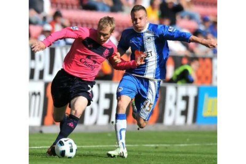 Wigan Athletic's Tom Cleverley, right, and Everton's Tony Hibbert in the thick of action yesterday. Andrew Yates / AFP