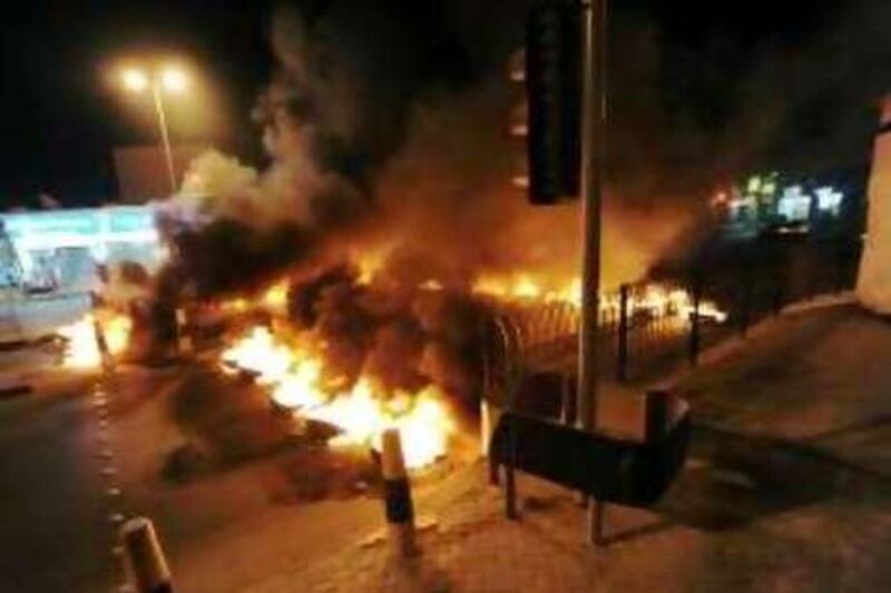 Tyres burn at a key intersection in Tubli village on the outskirts of capital Manama on Monday night