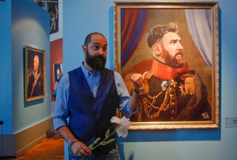 Italian artist Fabrizio Birimbelli stands next to a portrait of Argentina's Lionel Messi drawn by him at the Museum of Academy of Arts in St.Petersburg, Russia. Dmitri Lovetsky / AP Photo