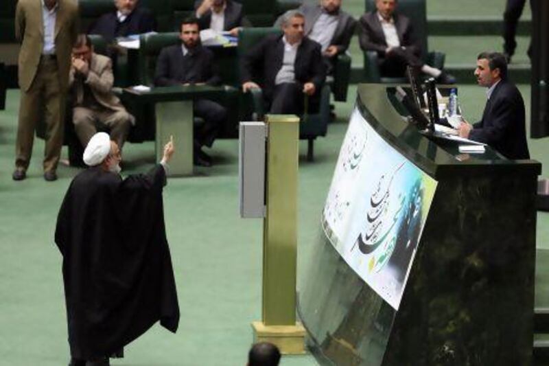 An Iranian member of parliament raises objections as Iranian President Mahmoud Ahmadinejad delivers a speech to parliament in Tehran this month. Atta Kenare / AFP