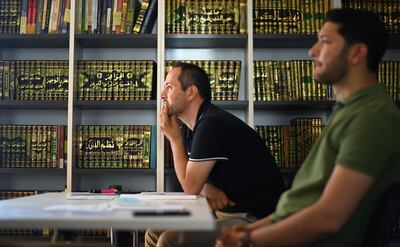 Students listen during a lesson in the classroom of the Islamkolleg Deutschland in Osnabrueck, western Germany on June 14, 2021. The first block course started on June 14 for the 35 collegiate students. A good half of them will start with imam training, the other Muslim clerics want to continue their training in cooperation with a university in a practical manner and across associations. Teaching of sermons, Qur'an recitation, pastoral care and church pedagogy are among the subjects on the curriculum.  / AFP / Ina FASSBENDER
