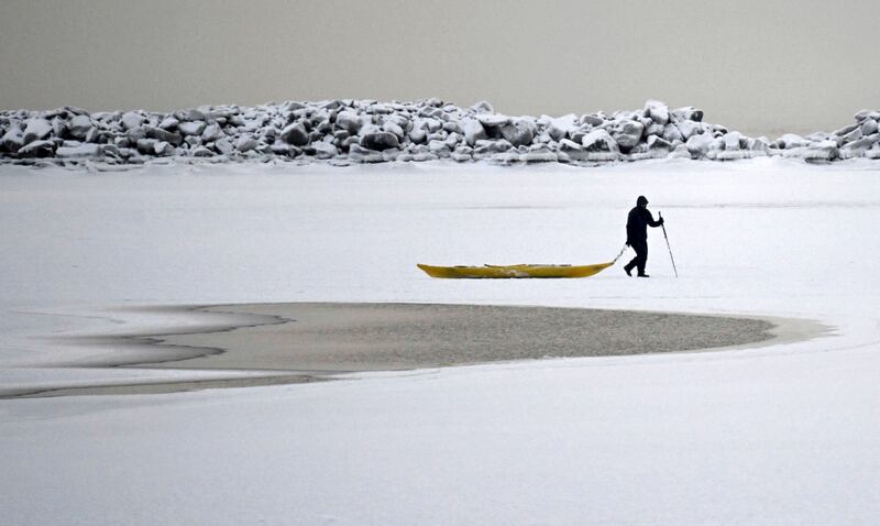 A man walks on the frozen sea in southern Helsinki, Finland. AP