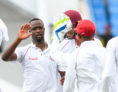 Kemar Roach (L) of West Indies celebrates the dismissal of Shakib Al Hasan of Bangladesh during day 1 of the 1st Test between West Indies and Bangladesh at Sir Vivian Richards Cricket Ground, North Sound, Antigua, on July 4, 2018. / AFP / Randy Brooks
