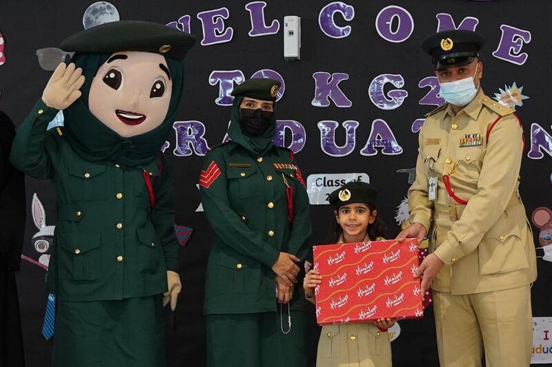 Hoor Hadad with Dubai Police officers and mascot Amna. Photo: Dubai Police