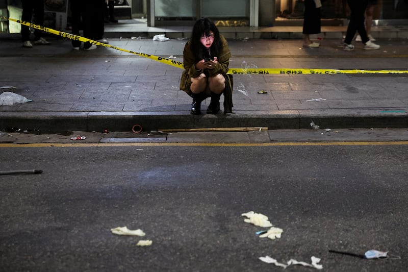 A woman makes a phone call near the scene. Reuters
