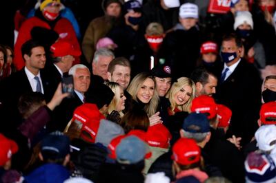 (L-R) Michael Boulos, Vice President Mike Pence, Tiffany Trump, Eric Trump, Lara Trump, Jared Kushner, Ivanka Trump and Donald Trump Jr. listen to US President Donald Trump speak during the final Make America Great Again rally of the 2020 US Presidential campaign at Gerald R. Ford International Airport on November 2, 2020, in Grand Rapids, Michigan. / AFP / JEFF KOWALSKY
