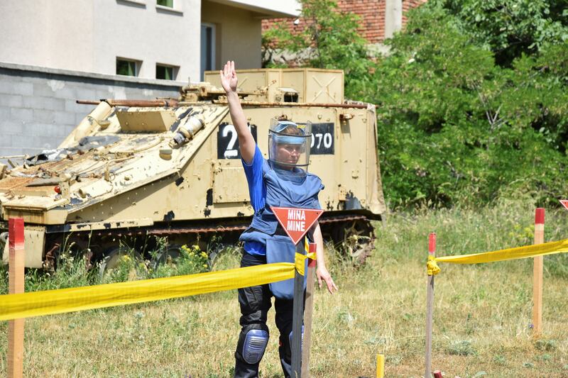 A woman gestures as a group of Ukrainians, including civilians and army officers, are trained in the removal of landmines and other unexploded ordnances, amid Russia's invasion of Ukraine in Peja, Kosovo, May 31, 2022. Reuters