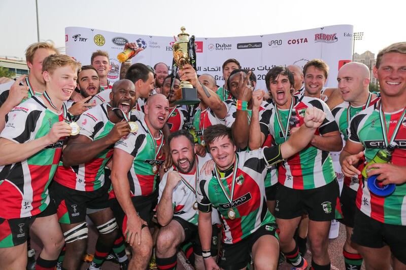 Abu Dhabi Harlequins celebrate their fifth trophy of the season. Victor Besa for The National