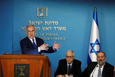 Israeli Prime Minister Benjamin Netanyahu gestures during a news conference as he stands next to Shlomo Mor-Yosef, Director General of the Israeli Population and Immigration Authority, and Israeli Interior Minister Aryeh Deri at the Prime Minister's office in Jerusalem April 2, 2018. REUTERS/Ronen Zvulun