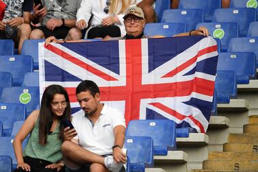 A man holds a British flag on the stands before the Euro 2020 soccer championship quarterfinal match between Ukraine and England at the Olympic stadium in Rome, Saturday, July 3, 2021.  (AP Photo / Ettore Ferrari, Pool)