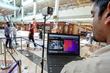 A technician operates a newly-installed thermal scanner at Khalidiyah Mall in Abu Dhabi. Victor Besa / The National