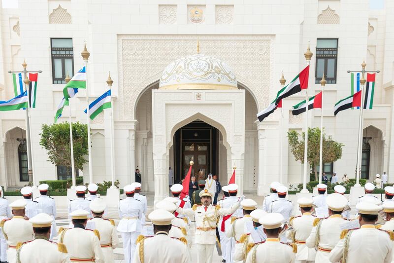 ABU DHABI, UNITED ARAB EMIRATES - March 25, 2019: HH Sheikh Mohamed bin Zayed Al Nahyan, Crown Prince of Abu Dhabi and Deputy Supreme Commander of the UAE Armed Forces (back R) and HE Shavkat Mirziyoyev, President of Uzbekistan (back L), stand for the national anthem during a reception at the Presidential Palace.

( Rashed Al Mansoori / Ministry of Presidential Affairs )
---