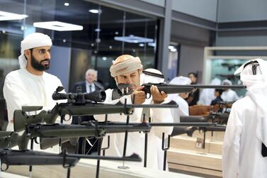 Visitors looking at guns at the Caracal stand at an exhibition in Abu Dhabi. Pawan Singh / The National 