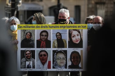Activists hold a sign demanding the release of human rights activists jailed in Iran near the Iranian embassy in Paris, France. EPA
