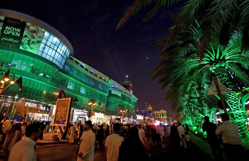 People walk on Tahlia street in the Saudi capital Riyadh on September 24, 2017, during celebrations for the anniversary of the founding of the kingdom. / AFP PHOTO / Fayez Nureldine