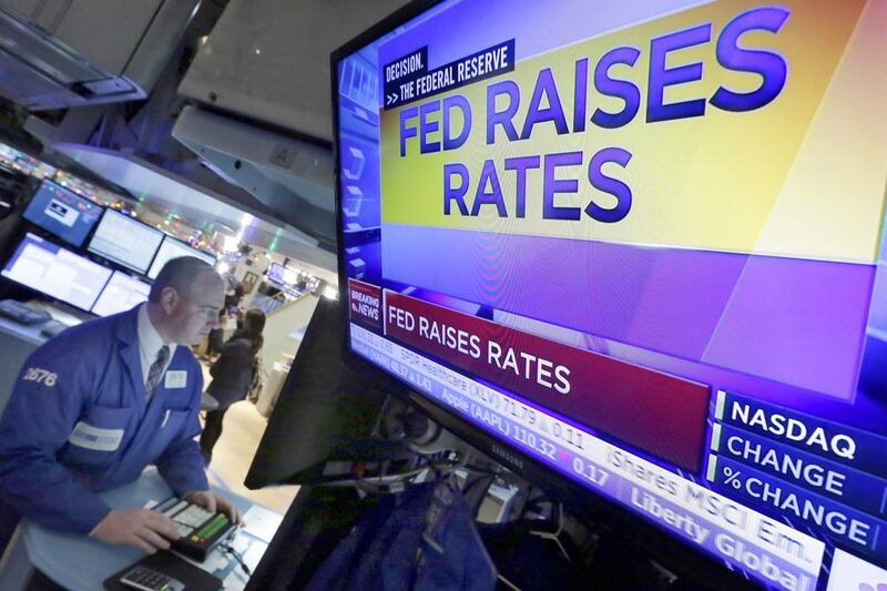 Specialist Edward Loggie works at his post on the floor of the New York Stock Exchange as the rate decision of the Federal Reserve is announced on December 16. Richard Drew / AP Photo