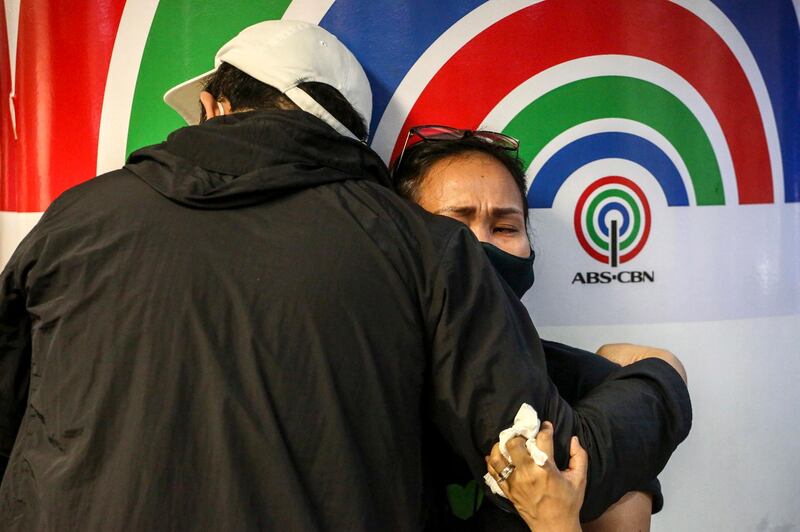 ABS-CBN employees react after Philippine MPs voted against renewing the network's broadcast franchise. EPA