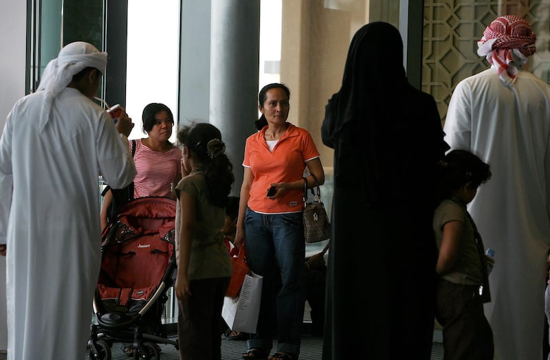 DUBAI, UNITED ARAB EMIRATES Ð June 30: House maids with one of the family at Dubai Mall in Dubai. (Pawan Singh / The National) *** Local Caption ***  PS05- MAID.jpg