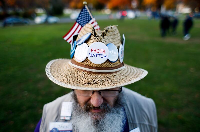 Jack Gavin, of West Caldwell, New Jersey, poses with some of the buttons he gave away during a get-out-the-vote rally with Democratic congressional candidate Mikie Sherrill in Livingston, New Jersey. EPA