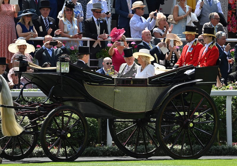 Prince Charles, Prince of Wales, and Camilla, Duchess of Cornwall, arrive in a horse-drawn carriage. AFP