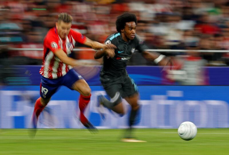 Chelsea's Willian dribbles past Atletico Madrid's Lucas Hernandez. Paul Hanna / Reuters