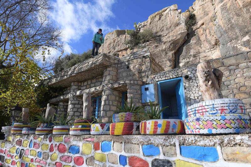 A Berber man stands atop a house in the Tunisian mountain village of Kesra. AFP