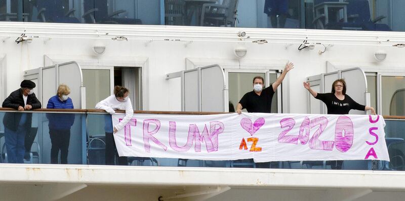 Passengers display a banner reading 'Trump 2020' on the deck of the cruise ship Diamond Princess. Kyodo / via Reuters